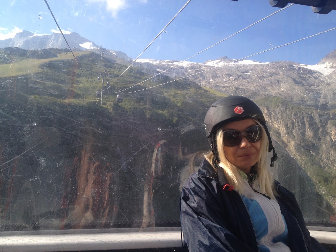 Civil Engineer and Blogger Vanja Keindl visited Gletchers arround the world on this picture she wears a helmet and behind is a gletcher in Austria