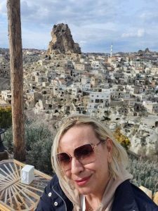 "vanja keindl travel blogger and civil engineer in front of stone houses in cappadocia"