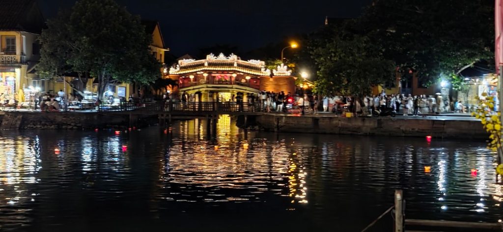 Bridge in Hoi An at night reflected in the river, Vietnam – photo: Vanja Keindl
